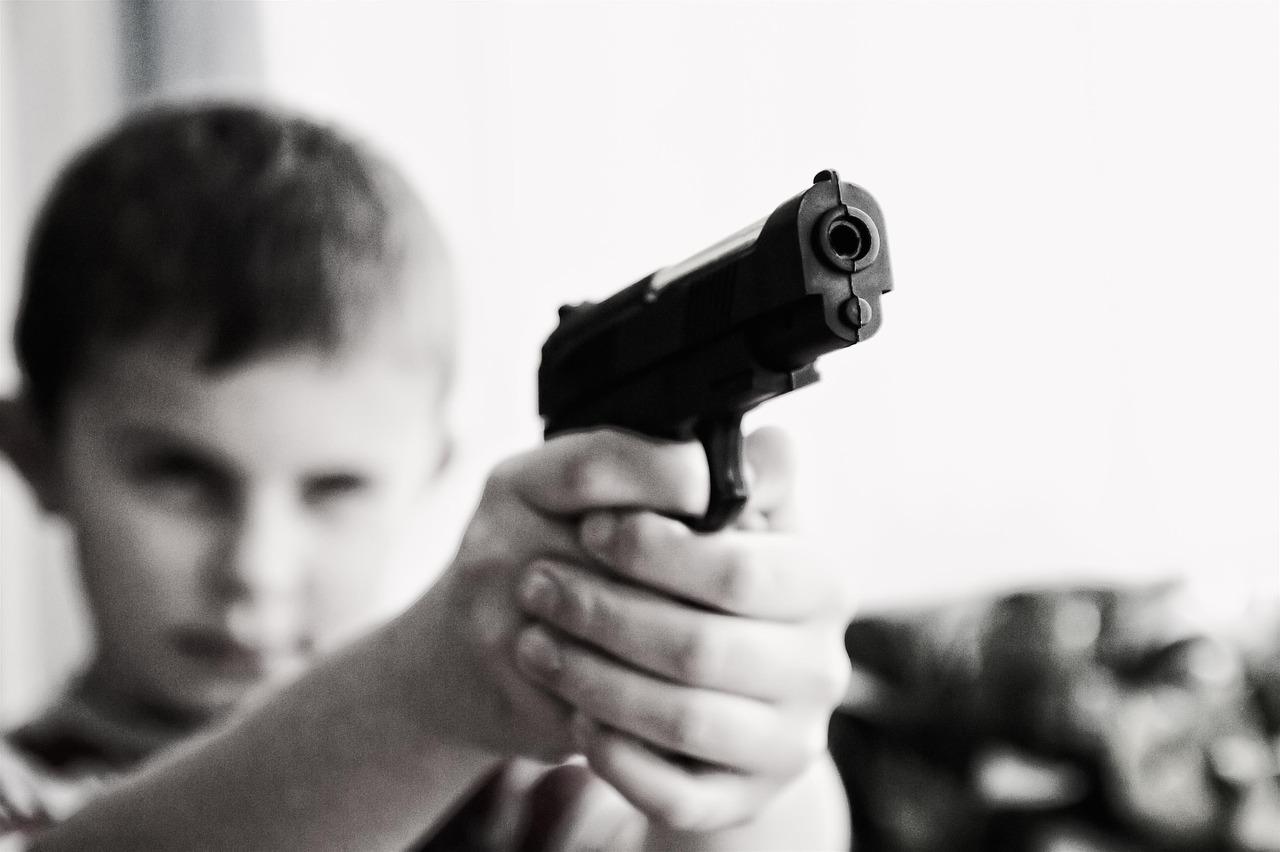 Kid pointing a gun